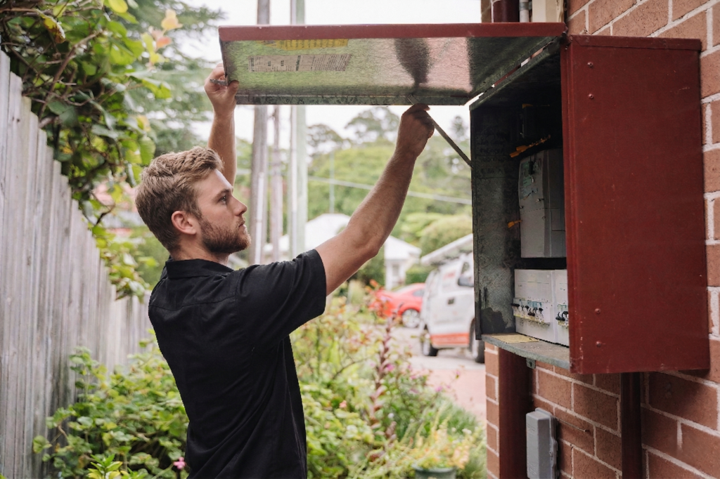 Electrician installing downlights in a Balgowlah home